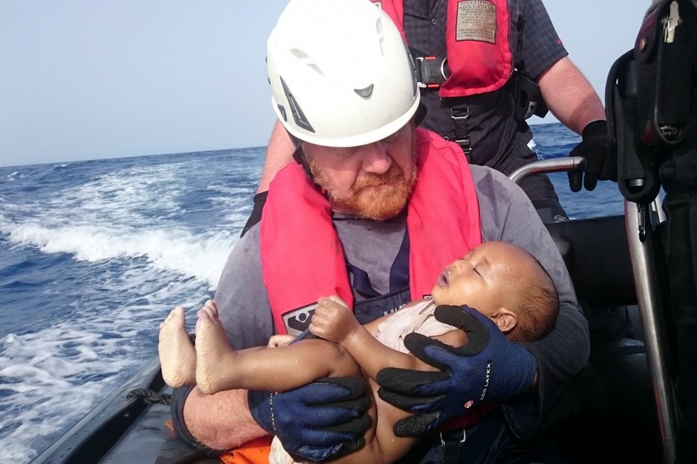 (VIDEO) FOTOGRAFIJA DANA: Spasilac nosi telo libijske bebe izbeglice