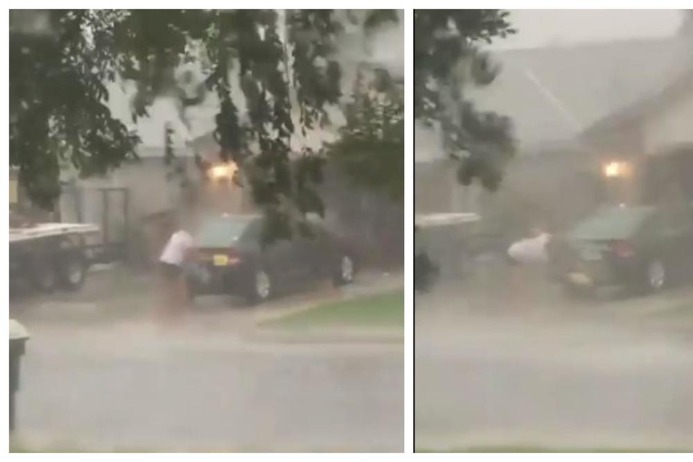 URAGAN LUDILO, SMEJE MU SE CELA AMERIKA: Rešio da pere kola po katastrofalnom pljusku, dok oluja nosi sve oko njega! (VIDEO)